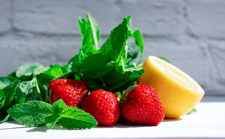 Lemon, mint, strawberry on a light background