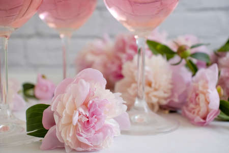 A glass of wine flower peony on a light backgroundの写真素材
