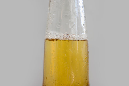 Bottle of beer close-up on a light backgroundの写真素材