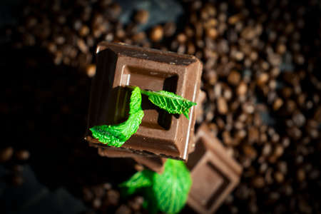 Chocolate, mint leaf, coffee beans on a dark backgroundの写真素材