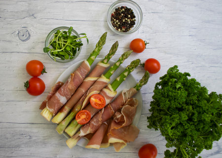 Fresh asparagus, bacon pieces, tomatoの写真素材