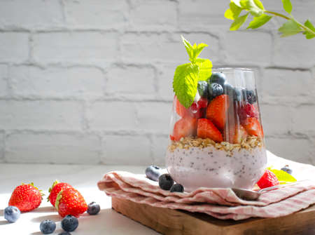 Yogurt, chia seeds, raspberries
, strawberries, blueberries, mint on a light backgroundの写真素材