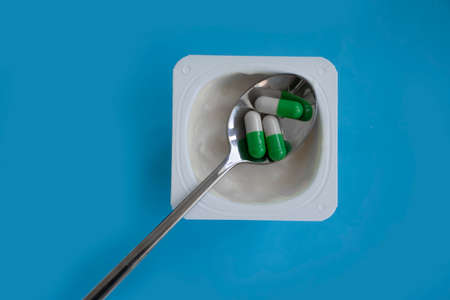 Yogurt in a plastic cup, probiotic capsuleの写真素材