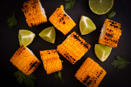 Grilled corn, lime on a dark backgroundの写真素材