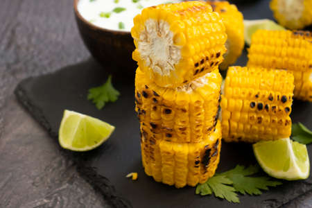 Grilled corn, lime on a dark backgroundの写真素材
