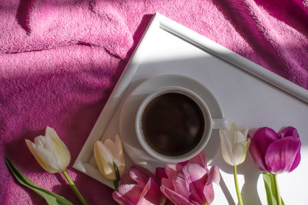 Cup of coffee tulip flower in the roomの写真素材