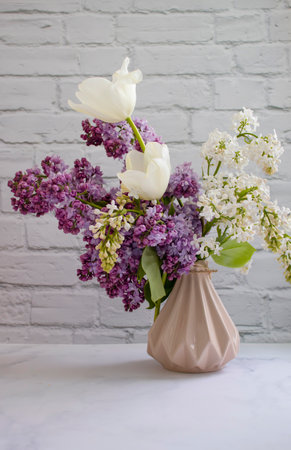 Beautiful bouquet of blooming lilacs in the roomの写真素材