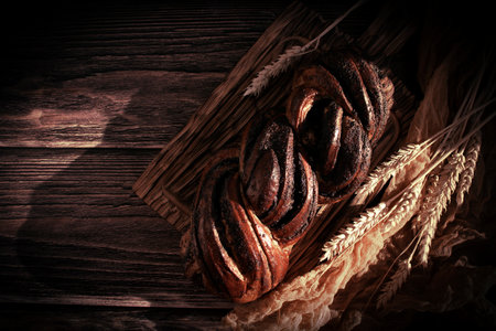 Appetizing bun with poppy seeds on an old backgroundの写真素材