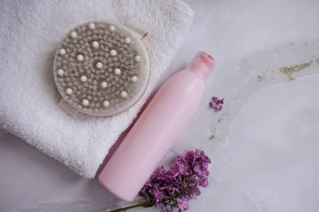 Shampoo, towel, massage brush on a colored backgroundの写真素材