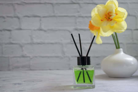 Perfume for home, flower on a light backgroundの写真素材