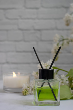 Perfume for home, flower, candle on a light backgroundの写真素材