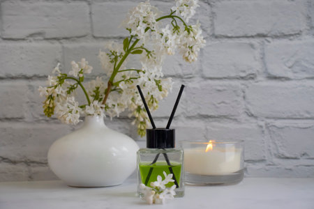 Perfume for home, flower, candle on a light backgroundの写真素材