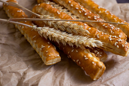 bread sticks with sesame seeds on old background