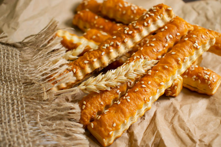 bread sticks with sesame seeds on old background