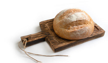 Bread on wooden board isolated on white backgroundの写真素材