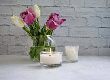 Tulip flower, candle on old backgroundの写真素材