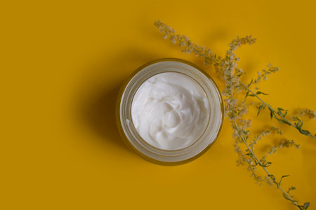 Cream cosmetic flower on colored backgroundの写真素材