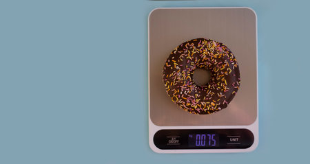 Cakes, kitchen scales on a colored backgroundの写真素材