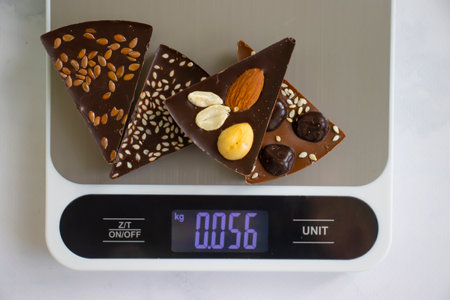 Chocolate, kitchen scales on a light background