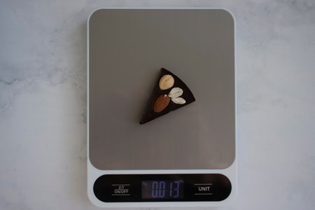Chocolate, kitchen scales on a light background