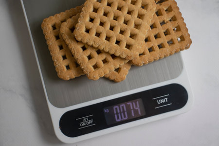 Cookies, kitchen scales on a light backgroundの写真素材
