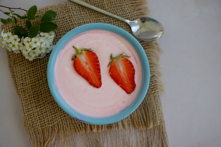 Yogurt with strawberries on a light backgroundの写真素材