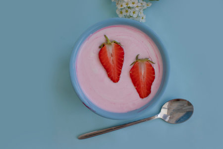 Yogurt with strawberries on a light backgroundの写真素材
