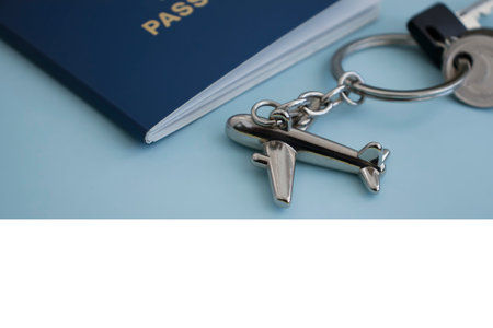 Passport, airplane keychain on a colored backgroundの写真素材