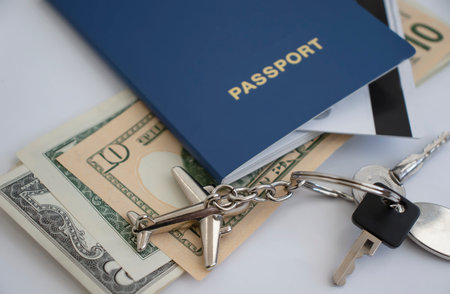Passport, dollar airplane keychain on a colored backgroundの写真素材