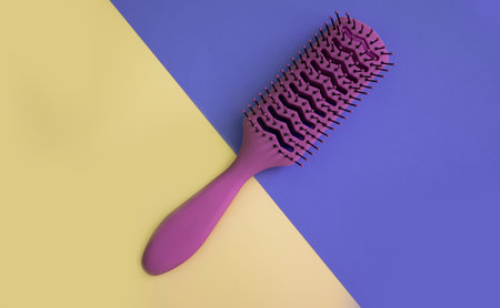 Hairbrush on colored background