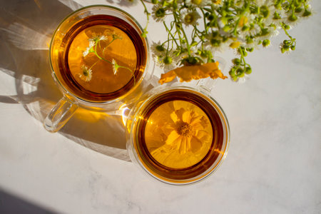 Tea with fresh chamomile on a light backgroundの写真素材