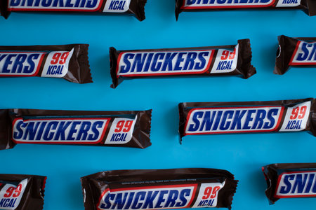 May 30 , 2022 Ukraine city of Kyiv chocolate bar Snickers on colored backgroundのeditorial素材