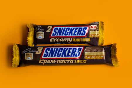 July 27, 2023 Ukraine city Kyiv chocolate Snickers on a colored backgroundのeditorial素材
