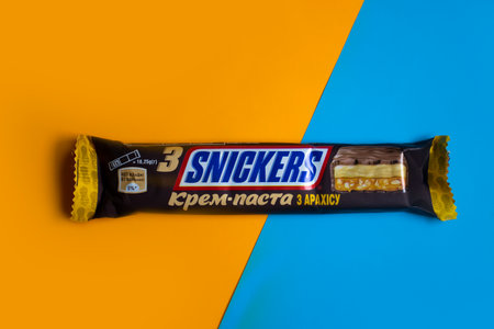July 27, 2023 Ukraine city Kyiv chocolate Snickers on a colored backgroundのeditorial素材