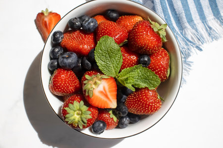 Strawberry, blueberry, mint in a bowlの写真素材