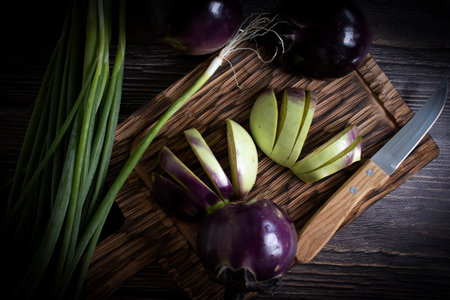Eggplant, green onion on old wooden backgroundの写真素材