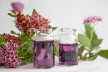 Cosmetic oil, flower on a light backgroundの写真素材