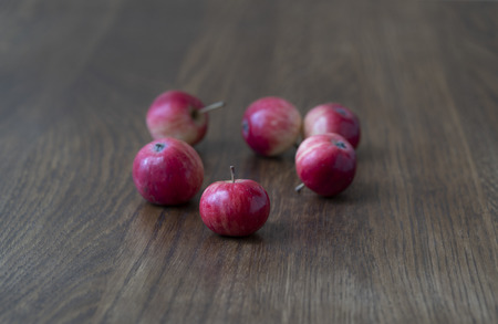 Red apples on a dark oak wooden surface.の写真素材