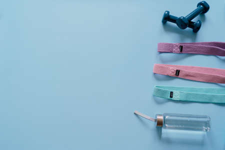 Sports background. Equipment for training. Fitness, workout at home. Flat lay, top view, copy spaceの写真素材