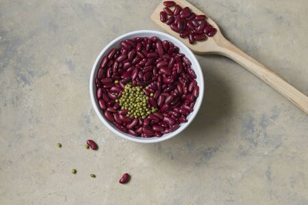 Legumes on a light background. Red bean and green mung bean in a light bowl. Healthy food for...