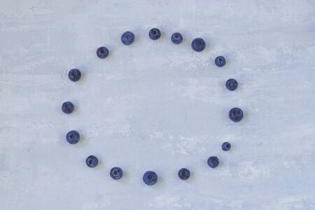 frame of blueberries. top view of forest berries on a light background. Horizontal position. Copy space.の写真素材