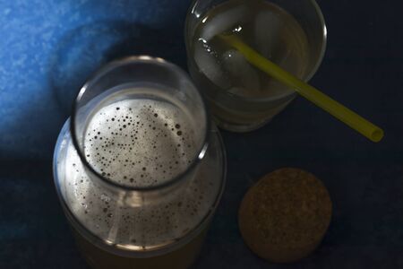 Healthy home-made fermented raw tea tea with natural probiotic properties. Kombucha in a glass bowl on a blue background. Horizontal position.の写真素材