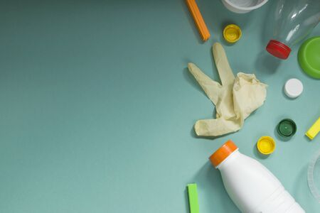 Plastic waste collection on a mint color background. Concept of Recycling plastic and ecology. Flat...