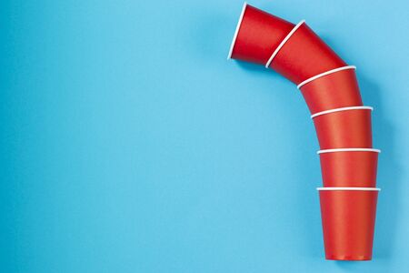 Paper cups on a blue background. Ecological tableware. Minimalistic style. Top view. Copy space.の写真素材