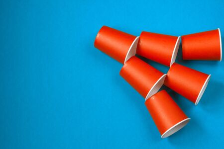 Paper cups on a blue background. Ecological tableware. Minimalistic style. Top view. Copy space.の写真素材