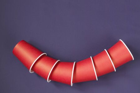 Paper cups on a dark background. Ecological tableware. Minimalistic style. Top view. Copy space.の写真素材