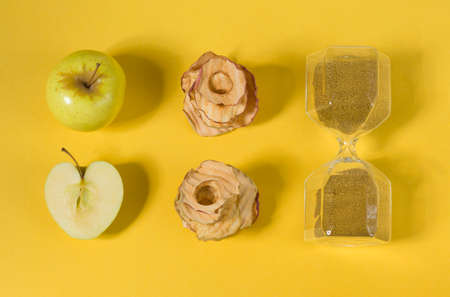 Natural apple chips on a yellow background. Healthy vegan vegetarian fruit snacks. Organic food for...
