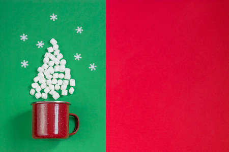 Christmas and New Year concept. Card with a Christmas tree made of marshmallows, a mug for a fot...
