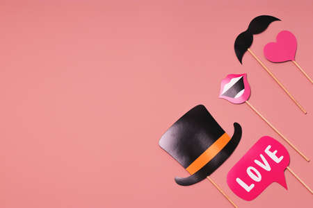 Party accessories on a pink background. Postcard concept for Valentines, Womens Day, Mothers Day, Birthday, Mens Day, Wedding Day. Flat lay, top view. Copy spaceの写真素材