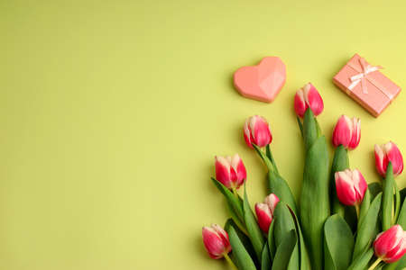Tulips bouquet, pink heart, gift boxes on a light background. Festive concept for Valentine's Day, Mother's Day, Women's Day and Birthday. Flatlay, copy spaceの写真素材